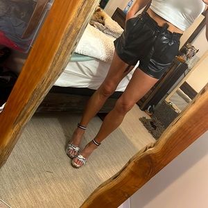 L high waist black faux leather paperbag shorts.